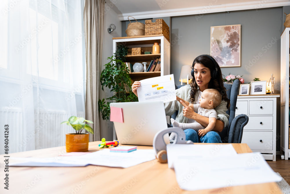 Business woman on maternity leave. Mother with newborn baby working from home using laptop. Female professional work at home office remotely video call conference on computer. - obrazy, fototapety, plakaty 