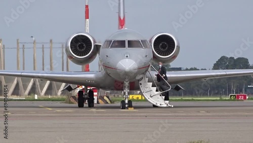 Pilot boarding Private Business Corporate Executive Jet at Regional Airfield Airport photo