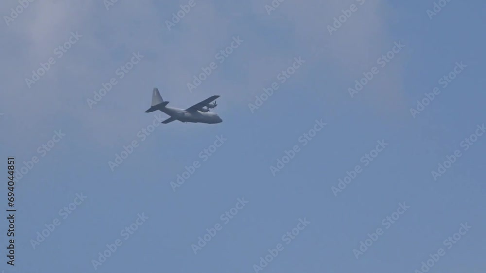 Military Transport aircraft seen flying in the distance through clouds on evacuation air bridge mission Military Transport aircraft seen flying in the distance through clouds on evacuation air bridge mission