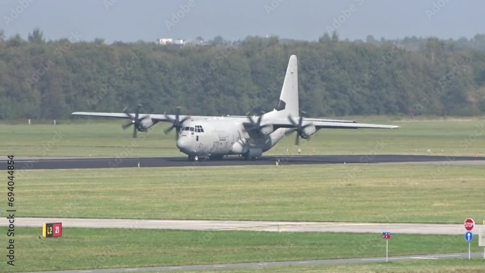Generic Military Army Transport airplane taxiing on the runway prior take off for a mission evacuation Generic Military Army Transport airplane taxiing on the runway prior take off for a mission evacuation