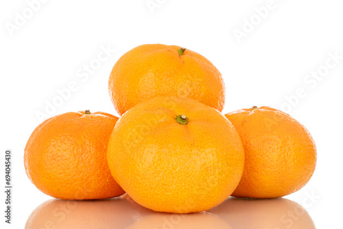 Several juicy fresh tangerines, macro, isolated on white background.
