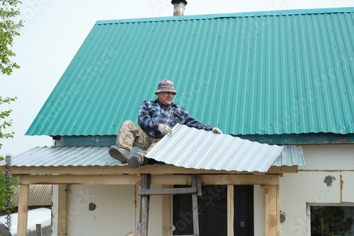 Wallpaper Mural The man on the roof, engaged in the act of repair, symbolizes the continuous effort required to keep a home in good condition against weathering challenges. Torontodigital.ca
