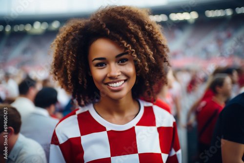 A young woman in a white and red checkered jersey, cheering for victory in a sports competition. Diverse team spirit. Generative ai image photo