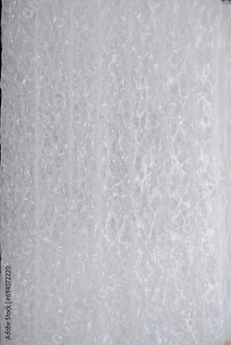 White carbon fibre foam surface.