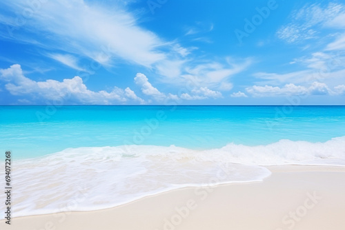 Beautiful sandy beach with white sand and rolling calm wave of turquoise ocean on Sunny day on background white clouds in blue sky