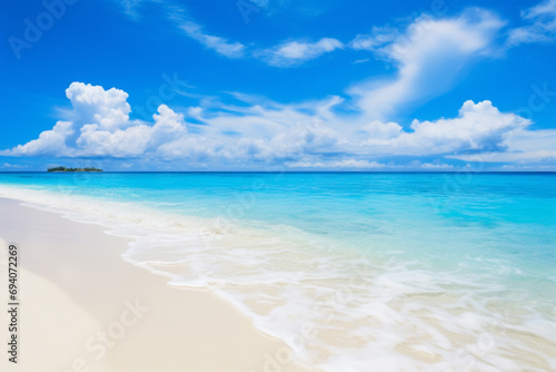 Beautiful sandy beach with white sand and rolling calm wave of turquoise ocean on Sunny day on background white clouds in blue sky