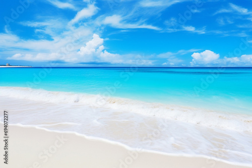 Beautiful sandy beach with white sand and rolling calm wave of turquoise ocean on Sunny day on background white clouds in blue sky