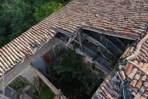 Quadro em tela Damaged roof tiles on an old abandoned building with a collapsed section