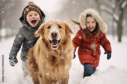 Golden retriever playing with kids in the snow.