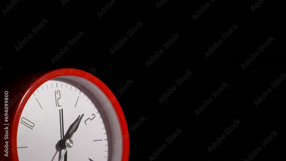Clock run faster on black background. A view of time on the clock run faster against black wall. A concept of troubled future time. Clock run faster on black background. A view of time on the clock run faster against black wall. A concept of troubled future time.