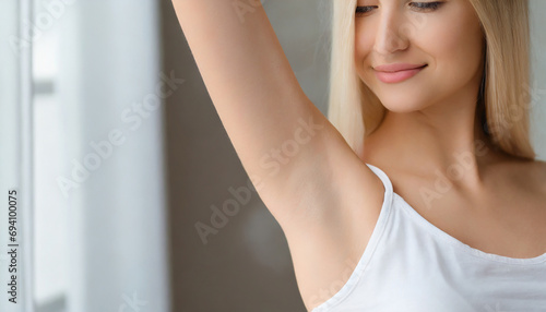 Armpit epilation, lacer hair removal. Young woman holding her arms up and showing clean underarms, depilation smooth clear skin .Beauty portrait photo