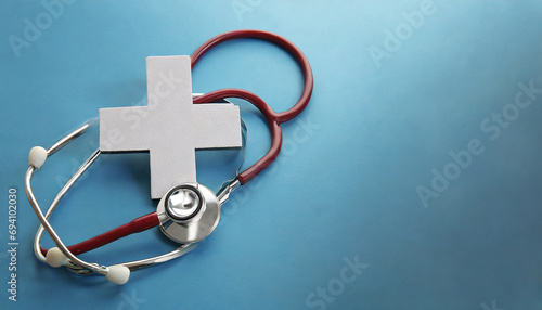 Health insurance concept. plus sign with stethoscope on blue background