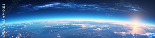Radiant sunrise over Earth's atmosphere. Earth Day concept. Global perspective. Space exploration. Panoramic design for banner, backdrop, or poster © dreamdes