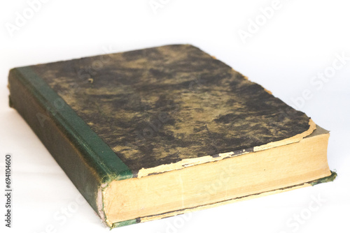 Vintage book in hard cover, white background, selective focus