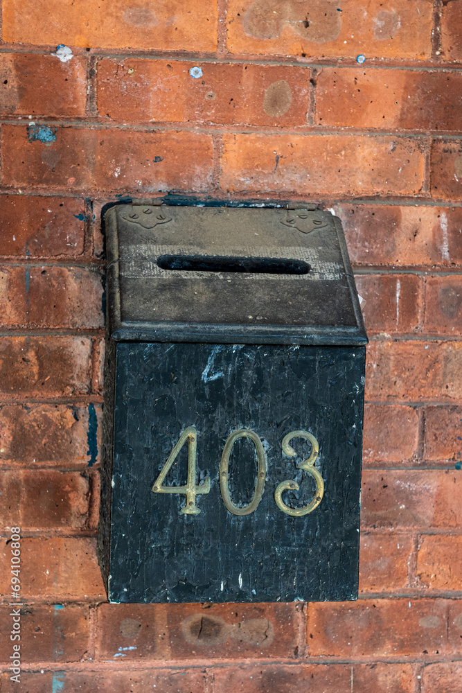 Old and rusty mailbox on a brick wall