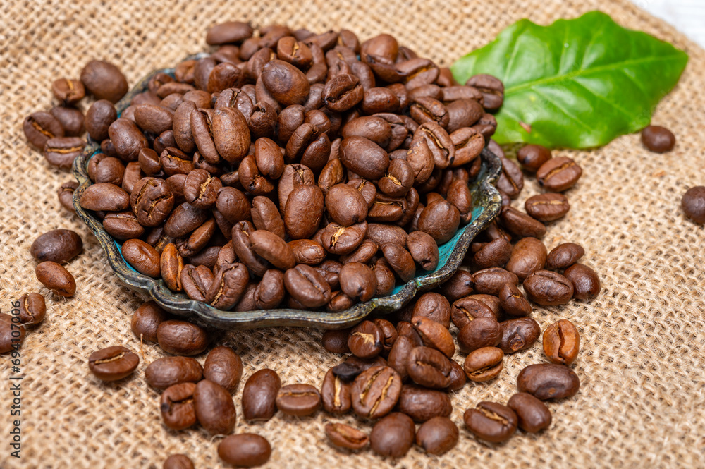 Fototapeta premium Arabica brown roasted coffee beans from Africa coffee producing region, cultivating in Ethiopia, Ivory Coast, Uganda, Kenya, Rwanda and Tanzania