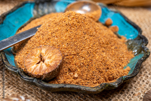 Bild auf Leinwand Tasty winter spice whole dried and ground powder nutmeg, used as an ingredient i