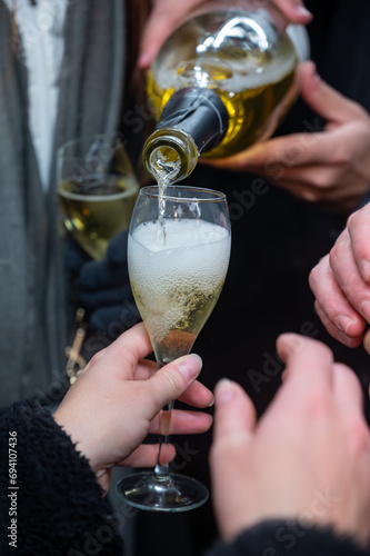 Visitors drink of sparkling wine champagne on outdoor winter festival in December on Avenue de Champagne, Epernay, Champagne region, France