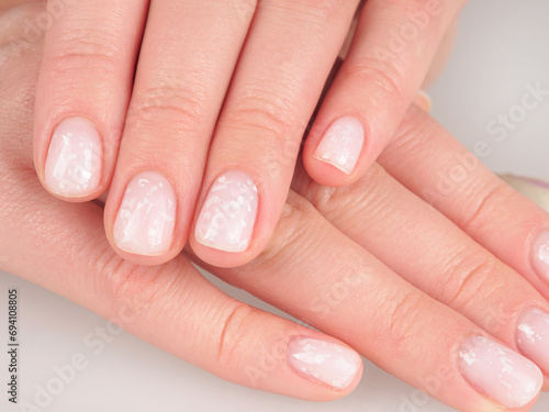 Women s manicure shellac soft pink color close-up