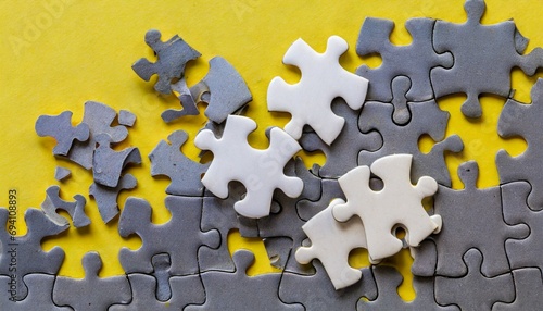 pieces of jigsaw puzzle on yellow background