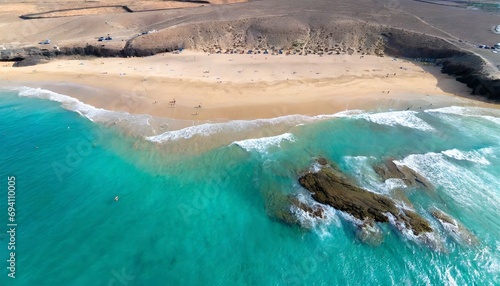 beach with turquoise water on fuerteventura island spain canary islands aerial view of sand beach ocean texture background top down view of beach by drone fuerteventura spain canary islands