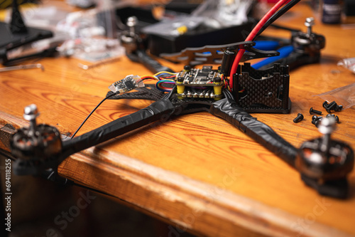 Frame, FPV racing drone frame, assembly, soldering, for the armed forces of Ukraine, installed with tools on the desktop, close-up view