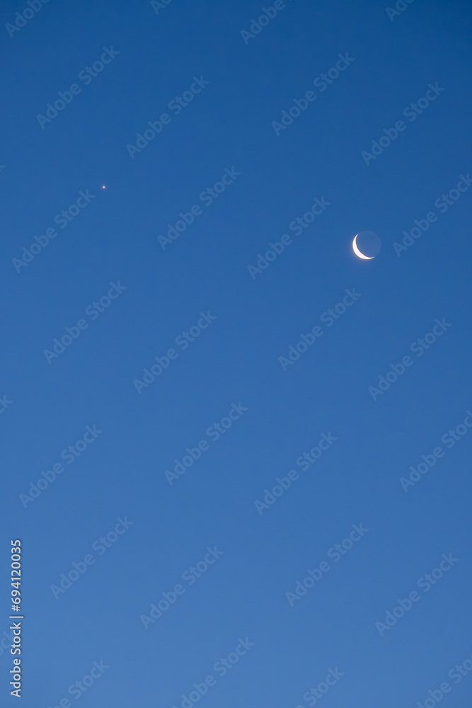 Night sky with old thin bright Moon and star Venus in the clouds, can be used as background. Night sky with old thin bright Moon and star Venus in the clouds, can be used as background.