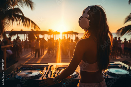 Young girl dj mixing outdoor during summer beach party at sunset time photo