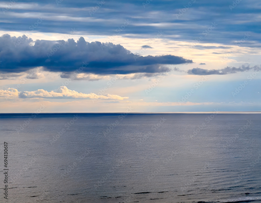 The horizon and the cloudy sky as a background, in the foreground