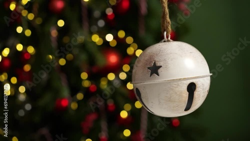 Big beautiful Christmas bell on the background of lanterns and Christmas tree. New Year and Christmas concept, beautiful holiday video.