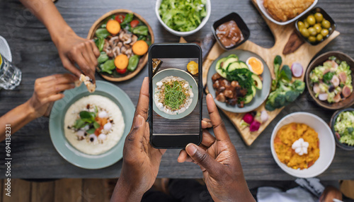 POV hands using a black smartphone to take a picture of the food placed on the table. Food concept.