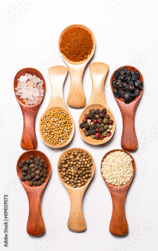 Fototapeta Naklejka Na Ścianę i Meble -  Many different spices in wooden spoons, background with different spices, spices on a white background