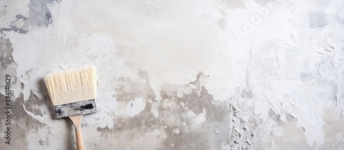 Renovating a house wall with putty or plaster and tools like a spatula.