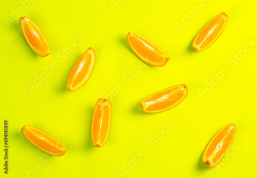 Orange orange slices on yellow background