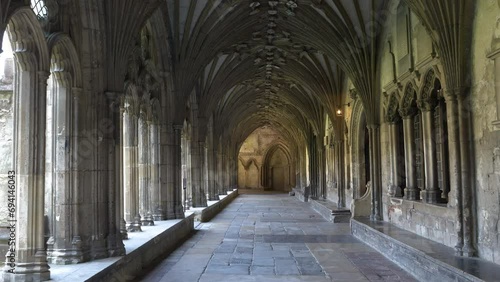 POV: Beautiful cloister with gothic arches in magnificent Canterbury Cathedral. Stunning architectural details of a religious and pilgrimage building in England, which is under UNESCO protection. photo