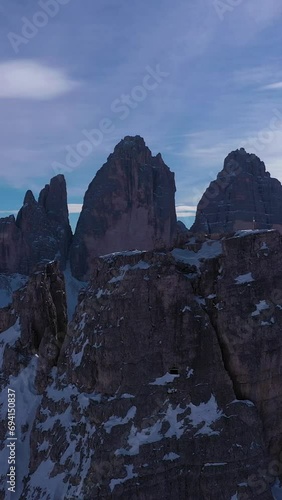 Tre Cime Di Lavaredo and Sextenstein. The Three Peaks on Sunny Day in Winter. Aerial View. Sexten Dolomites, South Tyrol, Alps. Italy. View from the North. Vertical Video photo