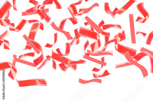 Bright red confetti falling on white background