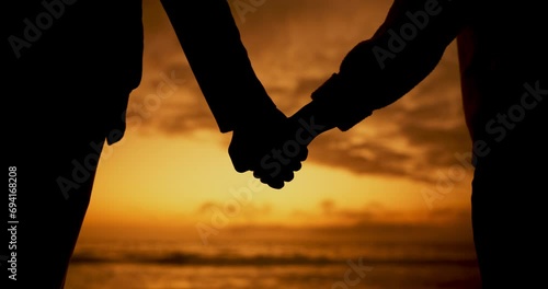 Beach silhouette, holding hands and sunset couple bonding, relax and enjoy quality time, ocean freedom or wellness. Marriage love, unity support care and people together at sea view, nature or dusk photo