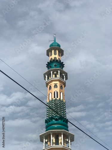The mosque tower stands high in the sky of pematang siantar indonesia photo