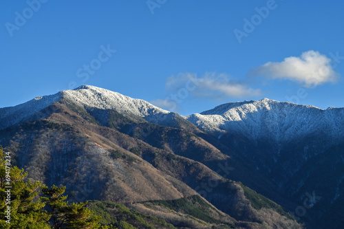 山頂付近が冠雪した山 © Basico