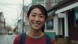A cheerful Asian American woman smiles on the street. Generative AI.