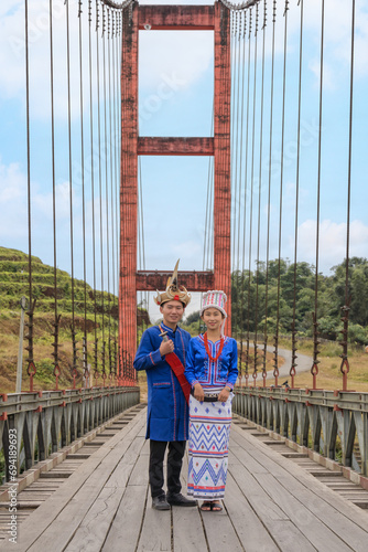 young couple of Rawang people in traditional Rawang dress at Kaungmulone Bridge across Mali Kha River in Putao, Kachin state. Myanmar photo