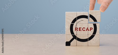 Recap on wooden cubes. Recap economy, business, financial concept. Business plan in 2024. RECAP words and magnifying glass icon on wooden cubes. copy space