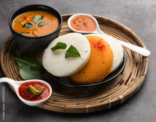 idly sambar or idli with sambhar and green, red chutney. popular south indian breakfast photo