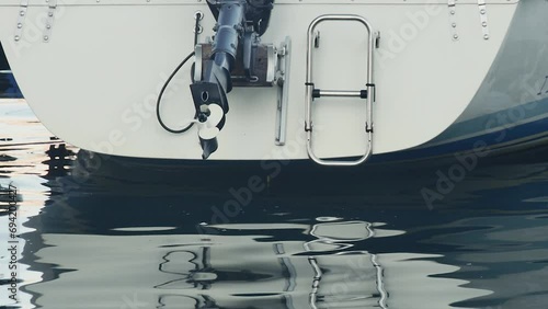  bottom view of the back of a boat with outboard motor photo