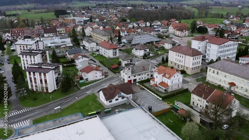 Flying Above Town Of Ribnica, Slovenia With View On City Architecture, Blocks, Houses, Intersection, Pedestrian Crossing, Crossroad With Cars Driving by. photo