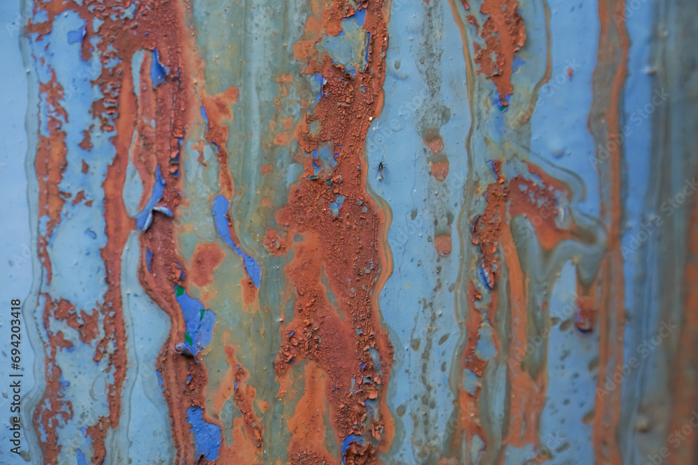 Abstract artistic background: rusty and painted blue iron.
