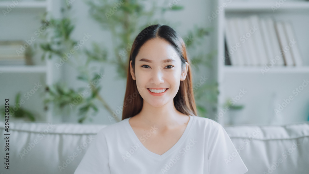 Front view of a cute young Asian woman smiling and looking at the camera. Happy facial expressions and positive emotions Front view of a cute young Asian woman smiling and looking at the camera. Happy facial expressions and positive emotions