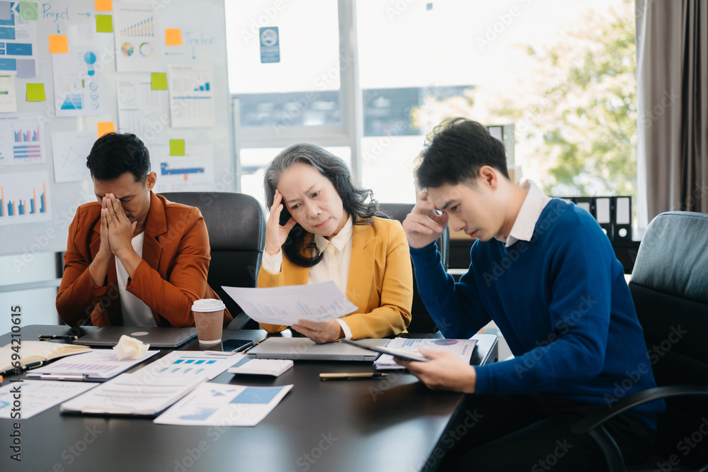 Team thinking of problem solution Furious two Asian businesspeople arguing strongly after making a mistake at work Team thinking of problem solution Furious two Asian businesspeople arguing strongly after making a mistake at work