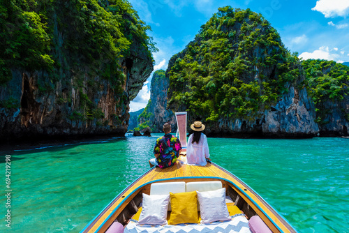 Luxury Longtail boat in Krabi Thailand, couple man, and woman on a trip at the tropical island 4 Island trip in Krabi Thailand. Asian woman and European man mid age on vacation in Thailand. photo
